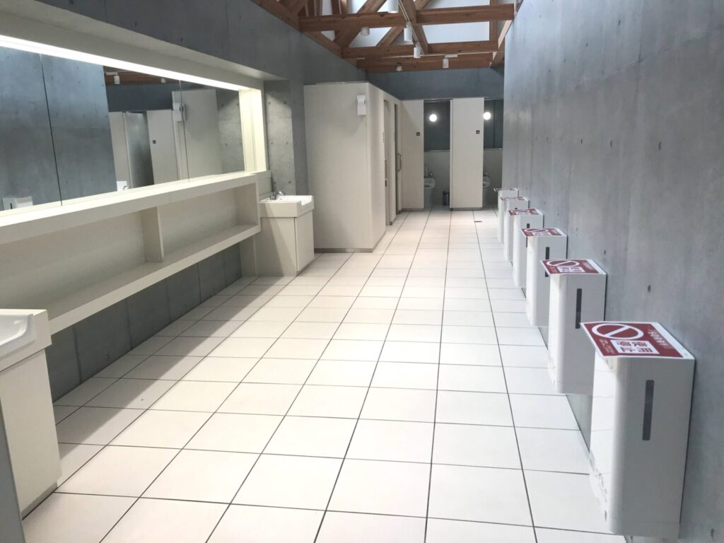 鏡張りで広々とした洗面エリアとトイレ通路