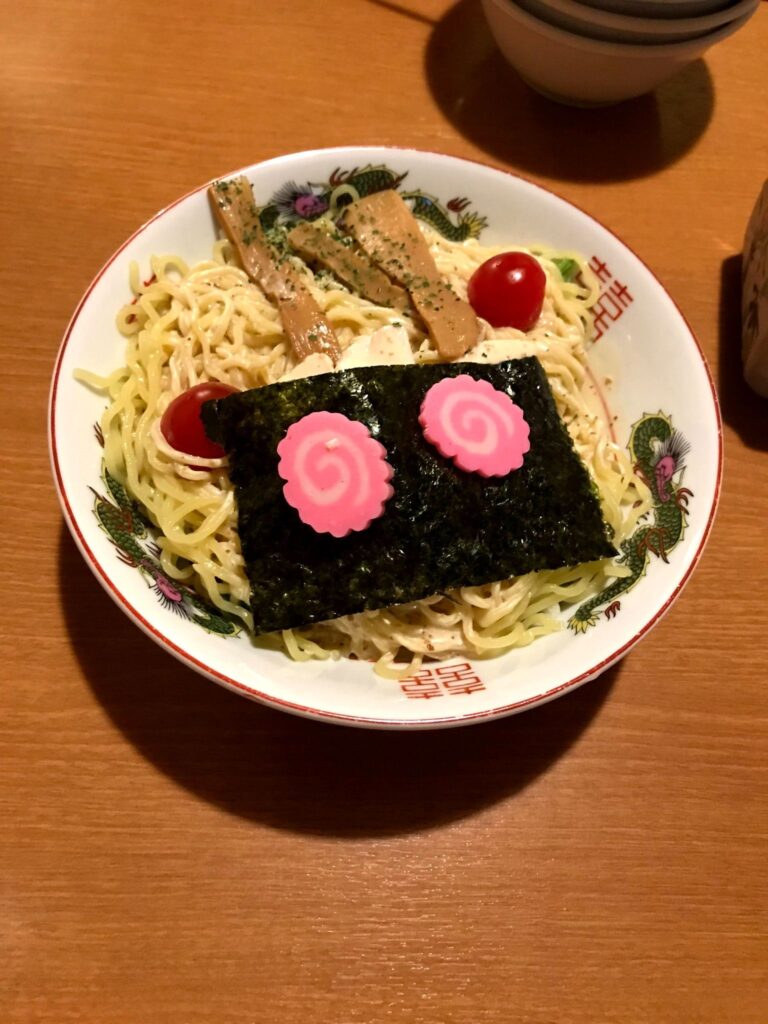 海苔とナルトがユニークに飾られた北海道のラーメンサラダの一皿