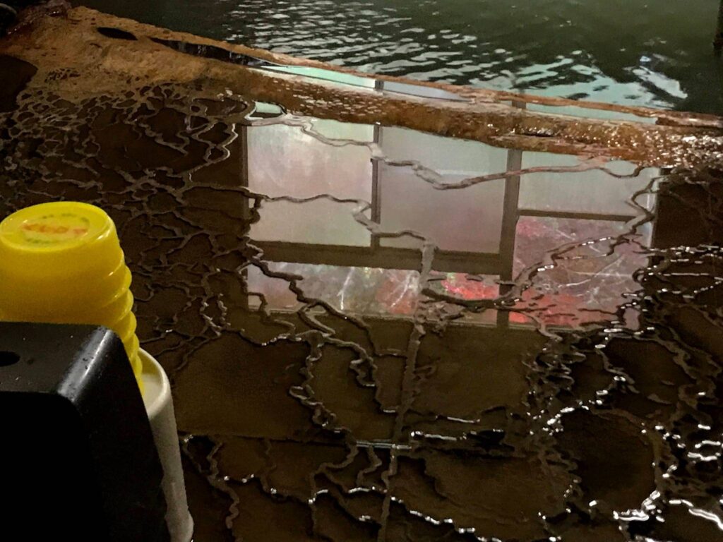 a yellow and white container next to a window
