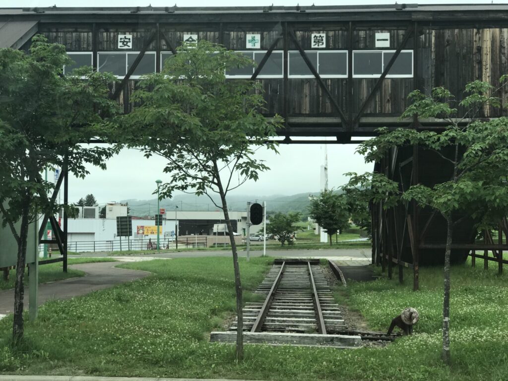本別駅跡の木造跨線橋と線路の先が見える緑に囲まれた風景